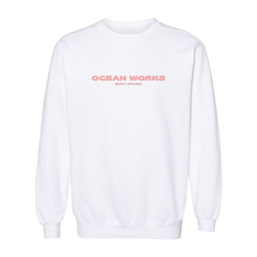 coral colored crewneck logo on white sweatshirt